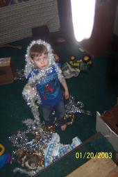 Elijah Being Creative and Learning - My son at Yule. We were decorating the house and tree. His job was to separate all the colors, name them, and count how many were in each pile. Afterward he greatly enjoyed mixing everything back up.