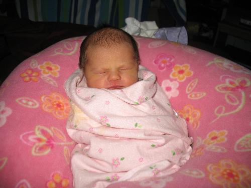 My daughter - This is a picture of my daughter. 2 days old, just home from the hospital. She's wrapped up in a receiving blanket and sleeping propped up in her boppy.