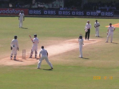 amit mishra to strauss - amit mishra getting ready to bowl to andrew strauss with some close in fielders around the bat....