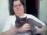Smokeybear - My 8 Year old male cat got infested with a mite called Waling Dandruff that made him very ill and he lost 11 Lbs. After treatment of dipping to kill these microscopic little nasties the vet suggested that it would be in his best interest to shave him to prevent any mites making it through treatment. Here he is in all his glory with me and as you can see he is not happy at all but boy is he ever soft. He is like petting velvet.