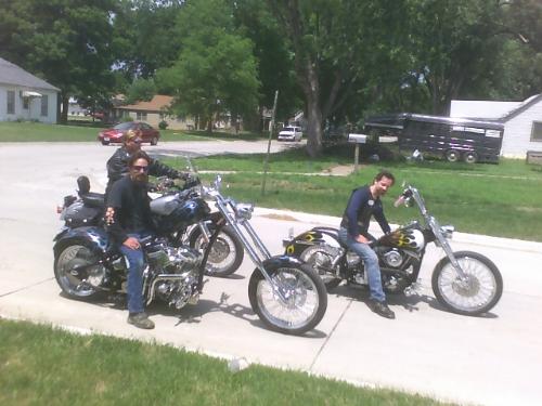 Memorial Ride with Brothers - My husbnd's bike is a 2000 Dyna Sport but you really can't see it as we were trying to get a picture of his two buddies who are actually brothers and don't like their mugshots taken. Guy Doyle built the stretched out ride you see pictured here with the big fat back tire, suicide clutch and flamed paint job. He also redid his brother, Chad Doyel's bike you see in the lead here.