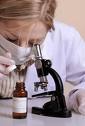 Female Scientist with Microscope - Forensic scientist with microscope