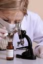 Forensic scientist - Female forensic scientist with microscope