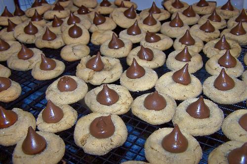 Peanut Butter Cookies Topped w/Hershey Kisses - These cookies are one of my favorites. I like making them, but I enjoy eating them more. Oddly, I eat the outer edges, take the 'kiss' off, eat the bottom, and then save the Hershey Kiss for last.