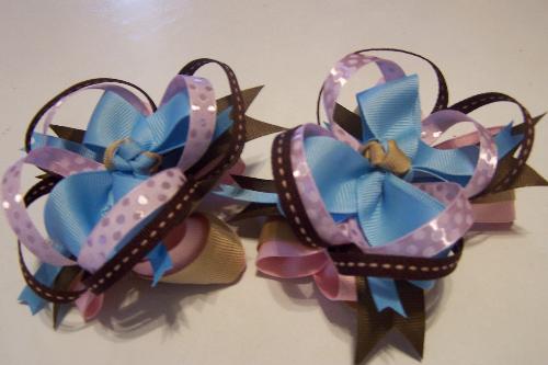 A Set of Boutique Hair Bows I've Made - I love to make fluffy and full pigtail bows. They look so beautiful in a little girl's hair. Can be made to coordinate any outfit or line. I also make single bows; I paint likenesses of characters as well.