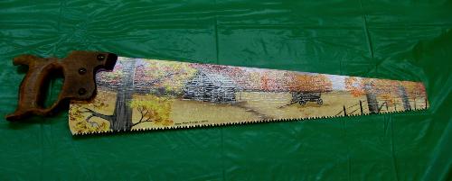 Painted saw - With so many country or should I say rustic cabins in the area items like this are in demand. Fall colors, a cabin and the wagon make this piece easy to fit in with any rustic decor.