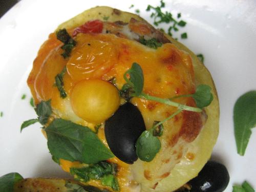 A stuffed potato - This is a Yukon Gold potato topped with a variety of home-grown hydroponic and organic veggies, including cherry tomatoes, chives, and basil, among other yummy veggies stuff, and mozarella and cheddar cheeses, as well as sausage.