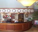 front desk management - Picture of guest services agent behind the front desk of a hotel