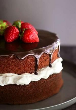 Chocolate Cake - Chocolate layers separated by creamy filling and topped with dark chocolate and strawberries.