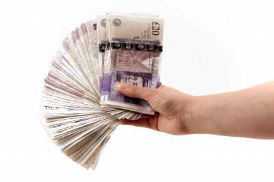 Cash In Hand - Man is giving away free money, easy steps how to earn money every day. Hands full of cash.