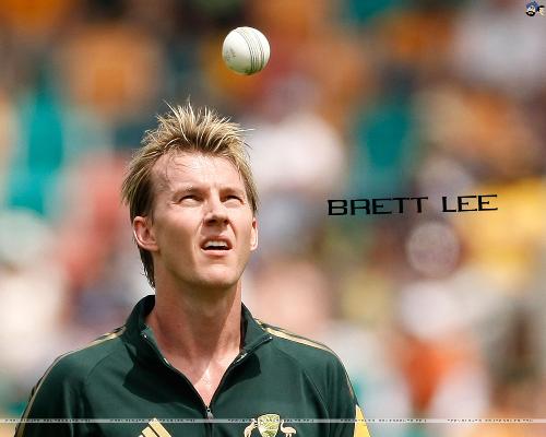 bret lee throwin ball into the air on his wasy bac - bret lee throwin ball into the air on his wasy back to to run up. typical style of bret lee