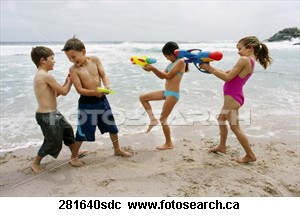 Enjoy life and have fun - Children playing on the beach, well laughing and having fun.