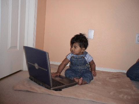 My grandson with laptop - I was astonished to see my grandson,pressing some keys and watching the monitor. So I took this photo immediately. His mother is a computer genius.She did her MS in computer engineering from Arizona State University in U.S. Is my grandson going to be another computer genius?