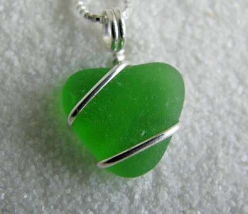 Green With Envy Sea Glass Necklace - I found some sea glass that the ocean tumbled into pretty heart-shaped pieces. Wrapped with sterling silver wire, these little hearts hang on sterling silver 18' chain.  The cobalt blue has already found a new home in Australia, leaving this pretty green piece,and a honey brown & frosty clear piece behind.