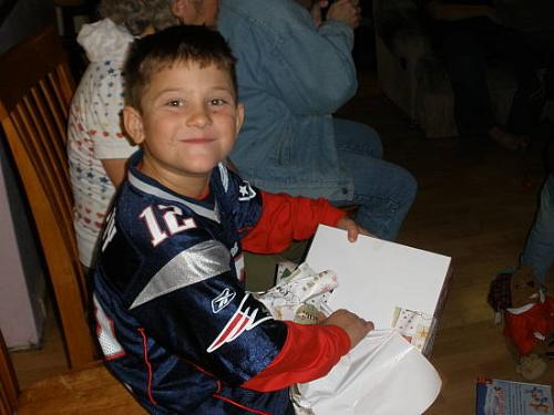 My eight year old opening a Christmas present this - My eight year old opening one of his Christmas presents