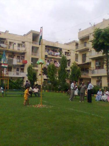 Child paying respect to National Flag - We hoisted National Flag in our apartments on 26 January.