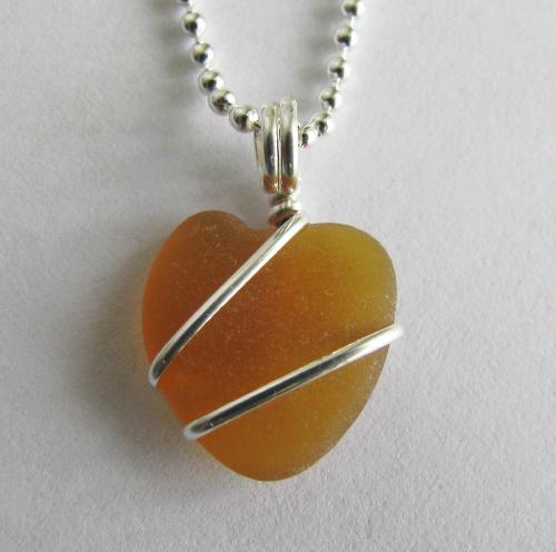 Honey Brown Sea Glass Heart Necklace - A beautiful piece of authentic honey brown sea glass is wrapped in sterling silver wire and hangs from an 18' sterling silver ball-style chain.