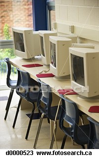 Row of computers in a classroom - Computers lined up in a row in a classroom setting