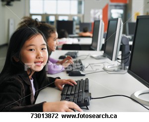 Students working on computers in the classroom - Young school children working on computers in thier classrooms
