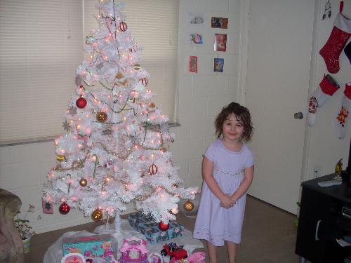 christmas time - my daughter standing around our tree