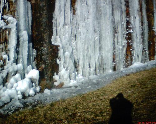 Ice cliffs - This is where the road cuts through the mountain to form a cliff. The water from rain flows down over the cliff and freezes. The spot in the center is where the ice has melted and the water is flowing. Ice cliffs - This is where the road cuts through the mountain to form a cliff. The water from rain flows down over the cliff and freezes. The spot in the center is where the ice has melted and the water is flowing.