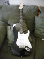 my guitar - its a black nd white fender squier. its a simple guitar, most begginers like myself buy this electriuc guitar or a simller one from a different brand.