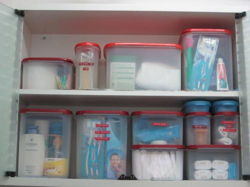 mess is waste organize and save - Bathroom cabinet organize storage space using Tupperware Modular Mates of various sizes.