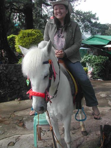 experience baguio - at 10 php, i was able to take my picture with this whitest horse i've ever seen!plus i've gotta try on the hippest cowgirl hat i town.. and oh not to mention the stool chair to assist me just in case i trip down which i'm thankful i did not