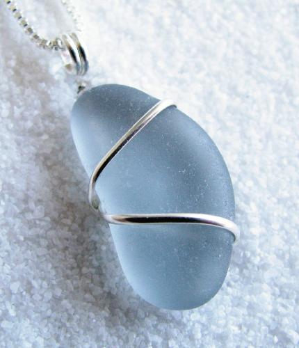 Tropical Storm Clouds Sea Glass Necklace - One of my creations using an extremely rare color of sea glass. The flawless piece of gray sea glass has been wrapped with sterling silver wire and hangs on an 18" Venetian box-style sterling silver chain.
Gray sea glass falls into the extremely rare color category. The chances of finding a piece of gray sea glass is approx once in every 2,000 pieces found. Finding an authentic piece as flawless as this is much harder. This piece has not been altered in any way. This is how the piece looked when it was plucked from the surf in Puerto Rico, naturally tumbled by the sea and sand. Tropical Storm Clouds Sea Glass Necklace - One of my creations using an extremely rare color of sea glass. The flawless piece of gray sea glass has been wrapped with sterling silver wire and hangs on an 18" Venetian box-style sterling silver chain.
Gray sea glass falls into the extremely rare color category. The chances of finding a piece of gray sea glass is approx once in every 2,000 pieces found. Finding an authentic piece as flawless as this is much harder. This piece has not been altered in any way. This is how the piece looked when it was plucked from the surf in Puerto Rico, naturally tumbled by the sea and sand.