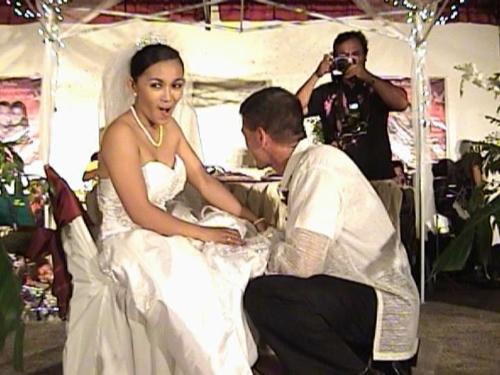taking of the garter - This is one of our wedding pictures. I like my face on photo as my hubby took off the garter from my leg. It tickled.