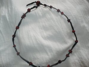 A necklace I made using fimo and a fake leather co - This necklace is about 20 inches long.The beads are made of polymer clay. the clasp is also made of beads. this hand crafted necklace is suitable or men or women. This necklace is for sale at http://lilnono.ecrater.com
