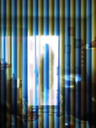 Awen through the looking-glass - Wierd picture of yours truly on the balcony as seen through the patio door.
