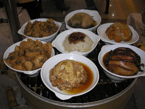 Chinese Food - This ia traditional Chinese Food. I took this picture in a small restaurant in Shandong Province. The one in the middle ia rice.Around the rice they are all kinds of meat,pork,beef, mutte and so on. Enjoy them!