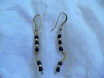 a pair of earrings I made using black and brass b - These earrings are made of gold plated copper and brass and polymer black beads