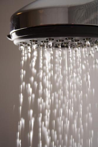 Shower - A showerhead that's turned on.