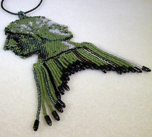 Janus Pendant - Free form brick stitch pendant of Janus. Fringe capped with hematite tubes.