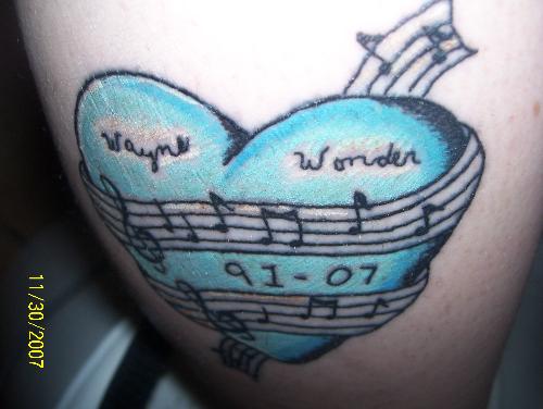 In memory of My nephew - This is my tattoo in memory of my nephew...every part of it has meaning to me and it would to him too...he would love it. The heart because no matter where he is...he will always be in my heart...blue, beacause we both love the color, and music because we were both passionate about it...he even wrote some of his own things too.  Miss ya Wayne...till we meet again