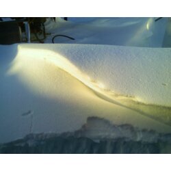 Sun on Snow - This was taken by the hubs of the sun hitting a snowbank late in the afternoon. You can just see an oil tanks and hoses at the top of the picture, and where the snowplow sheared the snowbank at the bottom.