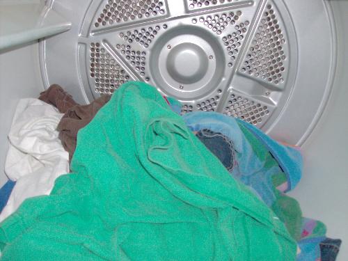 Laundry in a dryer - Loading the dryer less helps to dry clothes faster Laundry in a dryer - Loading the dryer less helps to dry clothes faster