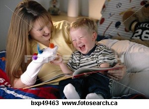 Mom and baby sitting on sofa laughing -  Toddler Laughing At Puppet