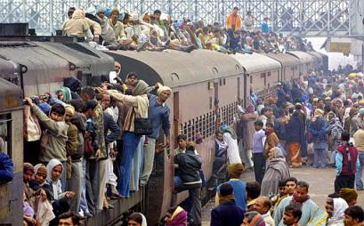 The train trying to say please have some mercy - This is the great Indian railway where people are trying to find a please to fit themselves in a train please don't get confused its not a building, between so many people there is an innocent train standing and getting torchered..
