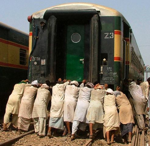 It happens only in India - I guess people forgot that its a boggie of a train and it has not got punchered or breakdown it has to be pulled by a locomotive(engine) anyway i guess they have got something personal with the boggie push push..