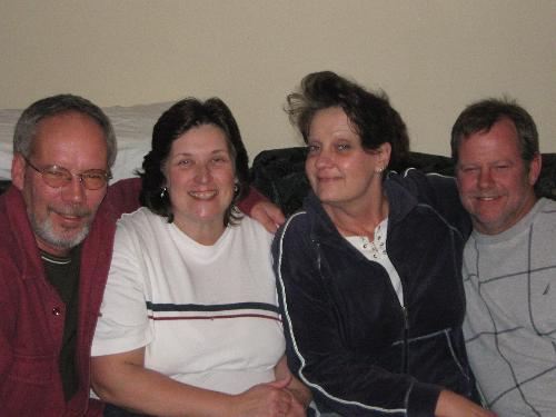 here is a picture of our friends, myself and my hu - here is a picture of our friends, myself and my hubby. the picture was taken on New Year's Eve at my friend's house.