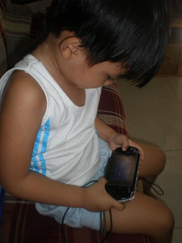 Addicted with PSP - My son playing his favorite game in his PSP.