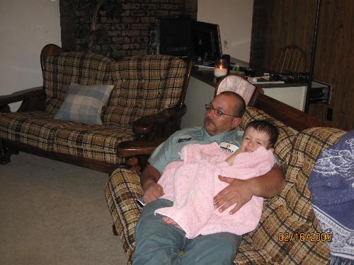 Snuggle time - A photo of my husband and son. My son just had a bath in this picture. He is wrapped in a towel and snuggling with dad.