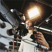 Television - Young man using a camera in a TV studio