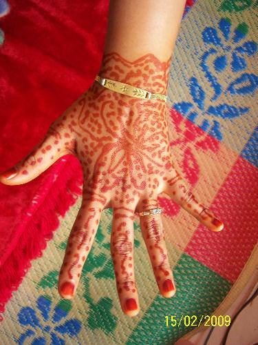 the bride hand is coloured with Inai - Inai is what they call for colouring the bride hand. some colour their feet also