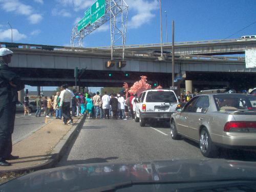 Indians blocking traffic - This was taken after the folk ahead of me on the last possible side street I could turn onto to get back to where I was going intersected with a traffic jam of people walking down the middle of the street in an Indian procession.