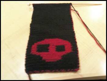 Skull Scarf - This is one of the projects im currently working on. its a scarf for my boyfriend. he made the pattern himself. its taking me forever tho because its done on size 3 (US) needles