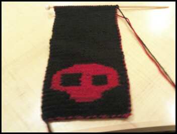 Skull Scarf - This scarf is done on size 3 needles. im using both black and red yarns. i have the other side of this scarf posted in my photos on my profile. my boyfriend is the one that made the pattern for me.